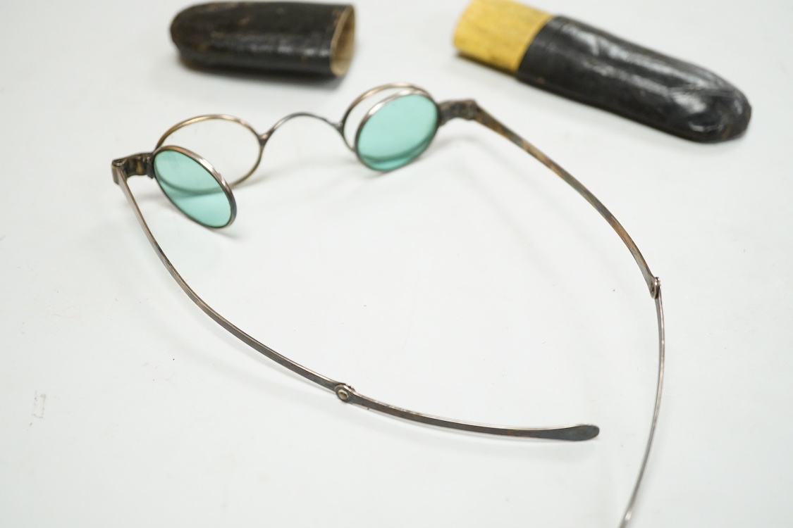 A pair of George IV silver turn pin hinged spectacles with tinted and clear double folding lenses, mm. H.I, London 1825, card case